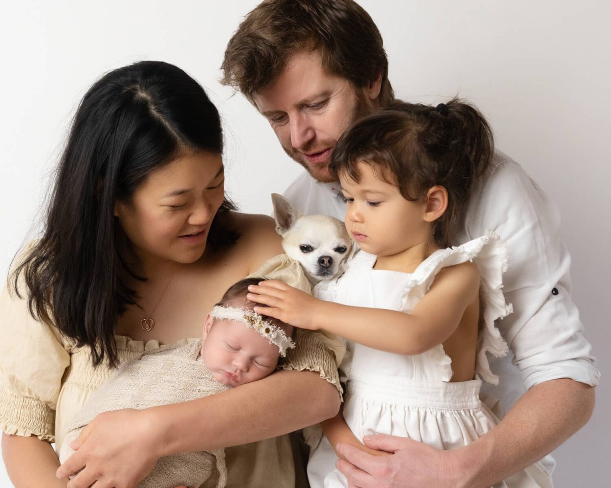 family with dog and newborn baby photography