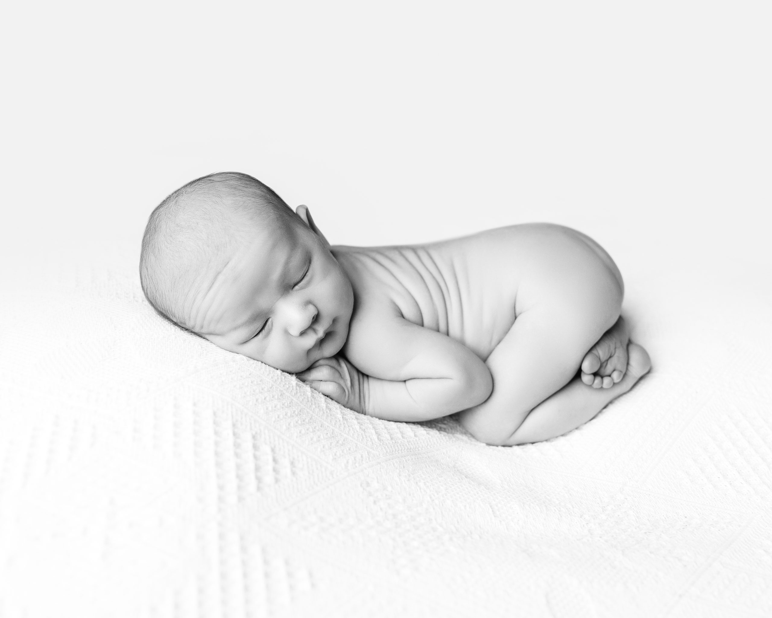 newborn sleeping baby black and white photography