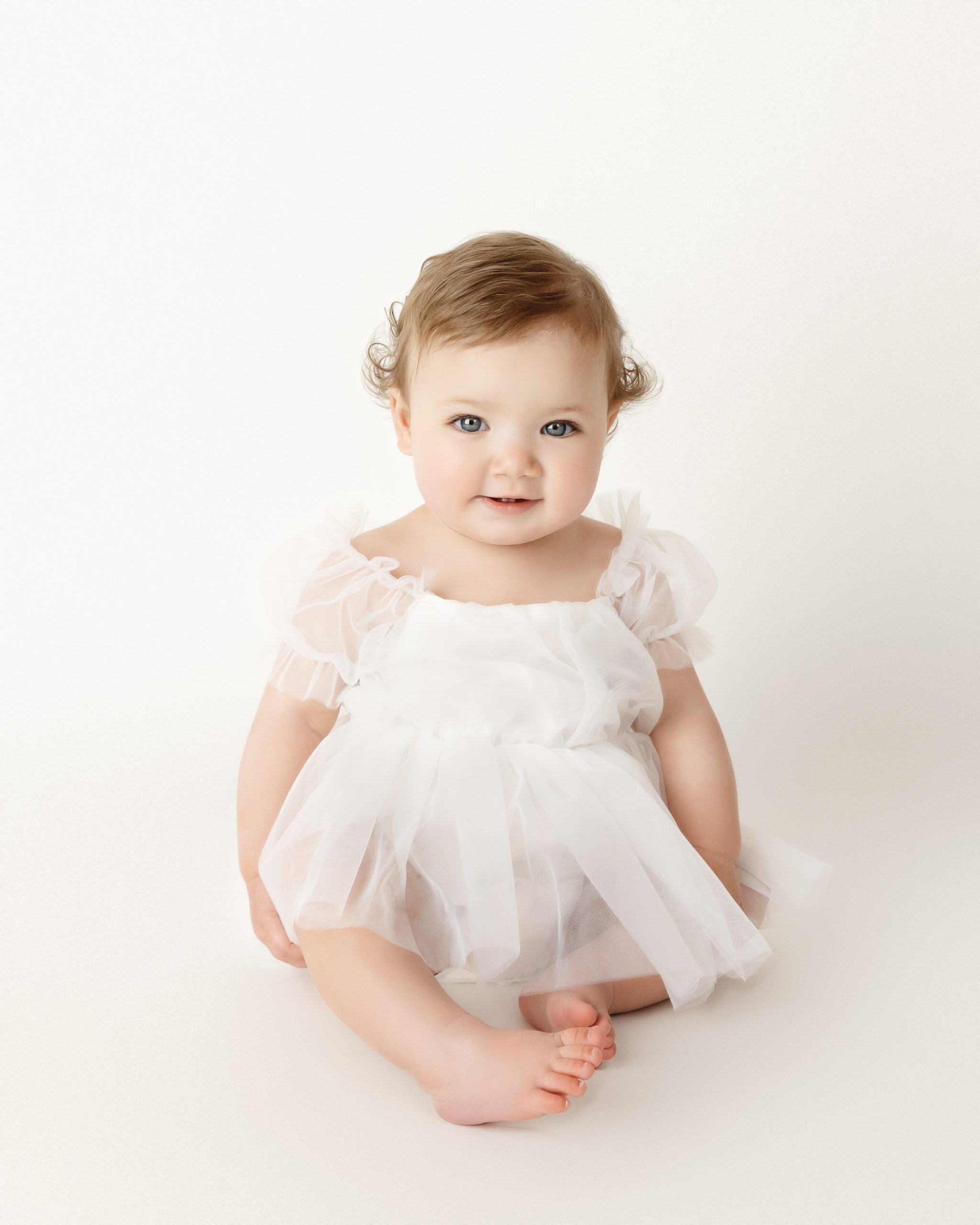 baby in white dress