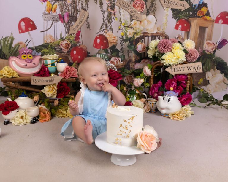 baby in blue with birthday cake in Alice in wonderland