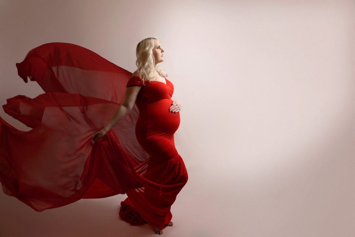 pregnant woman in red maternity outfit photography