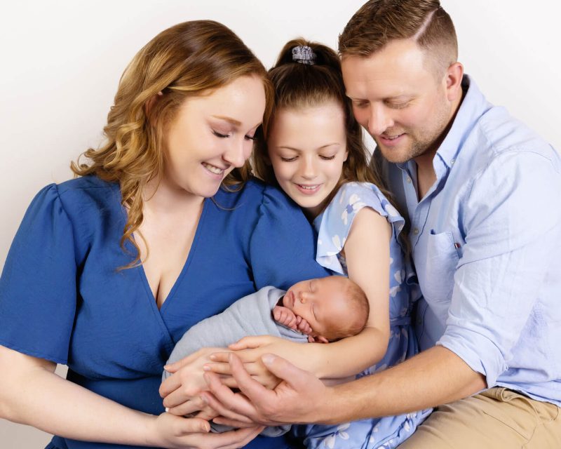 10 Common questions about Newborn Photography family in blue with newborn baby photography